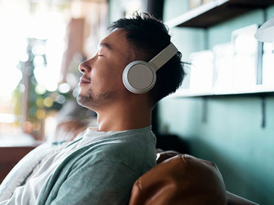 Man listening to music with a smile on his face.