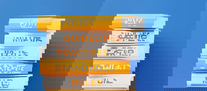 Stacked books showing Policy, Guidelines, Practices, Standards, and rules as titles on their spines.